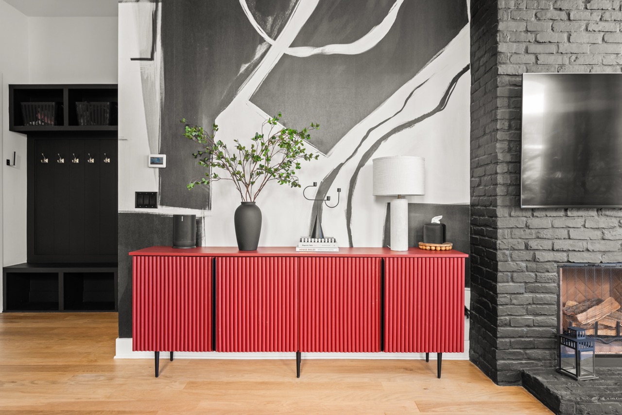 Entry hall with red fluted sideboard and painted mural