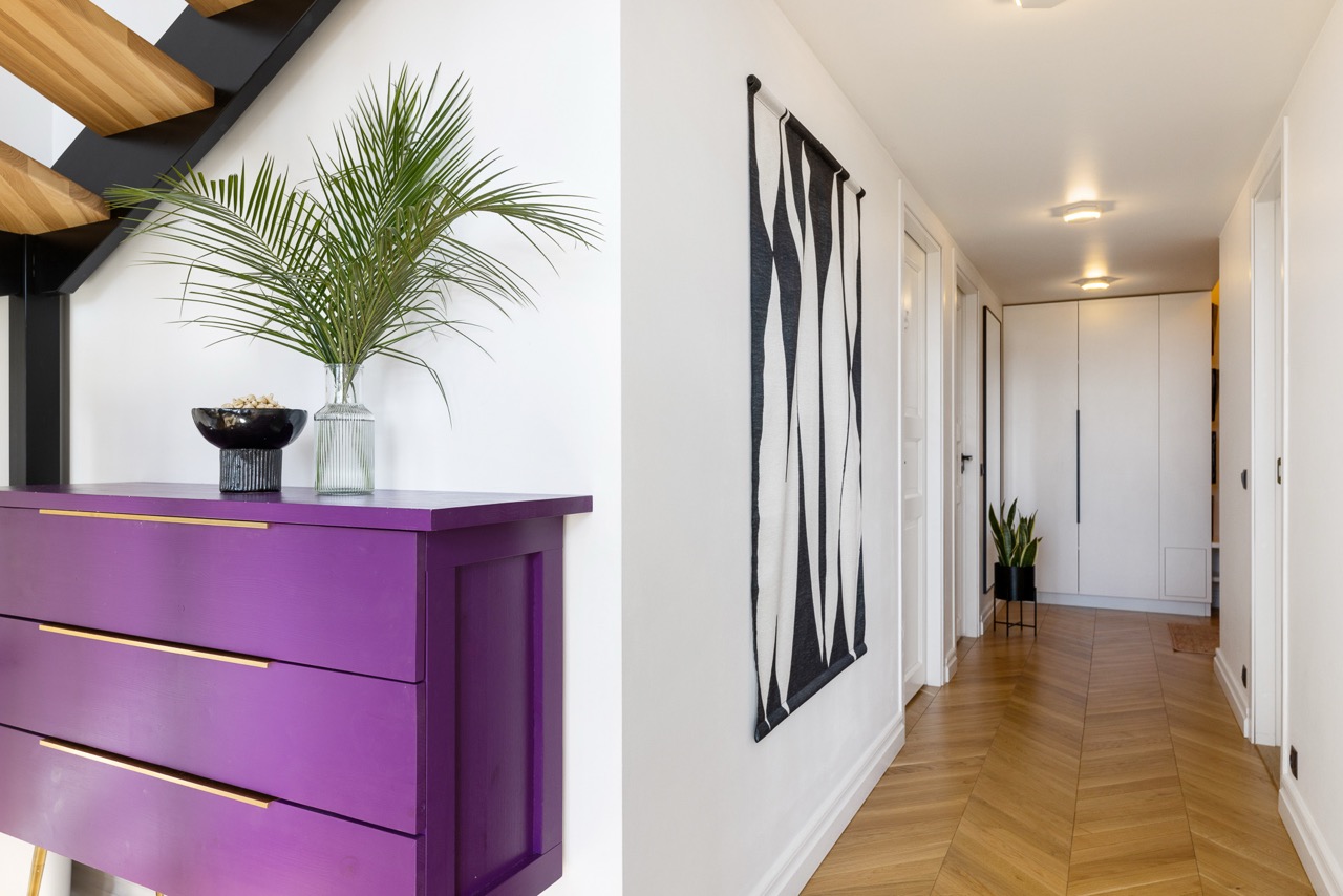 Hallway with lacquered chest and woven wall hanging